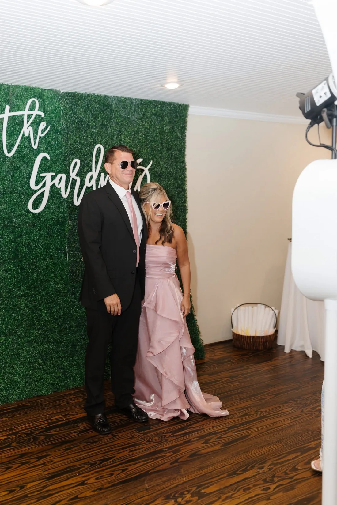 Couple posing full length at the open air booth.