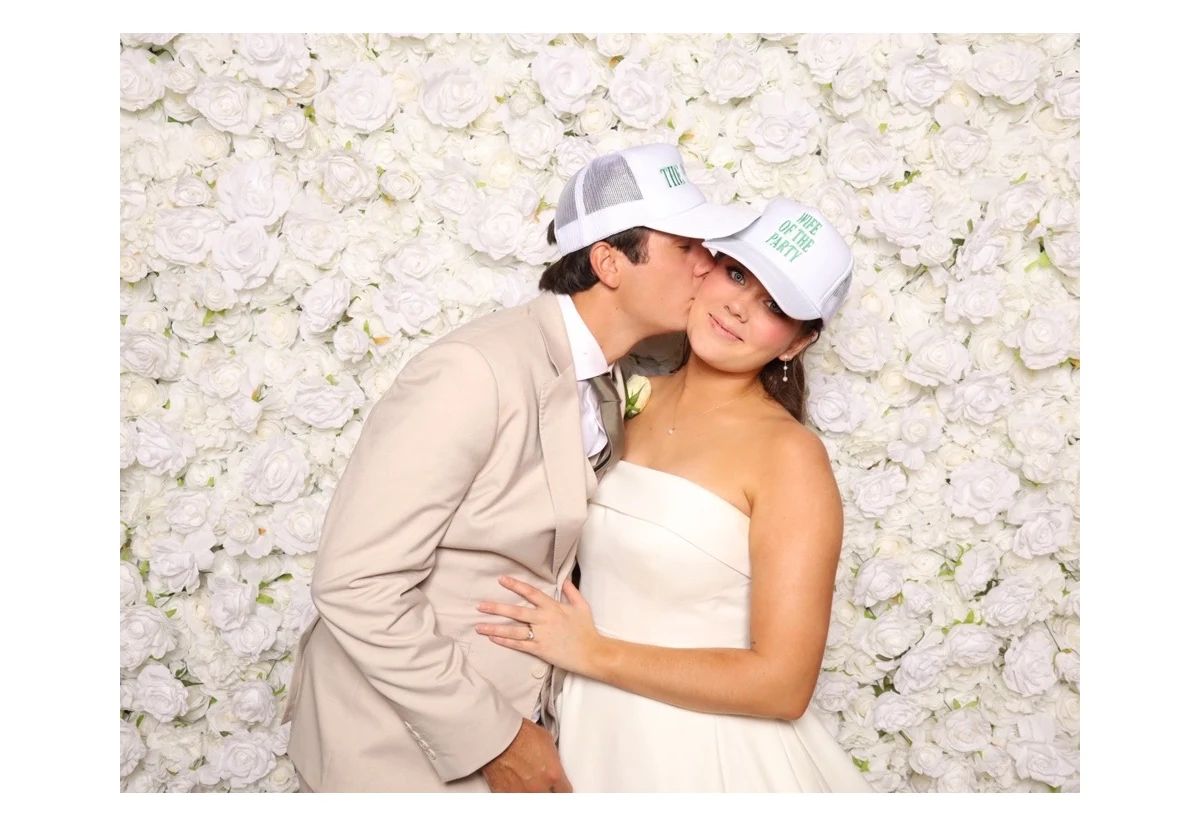 A finished print from the booth, a couple in front of the white flower wall.