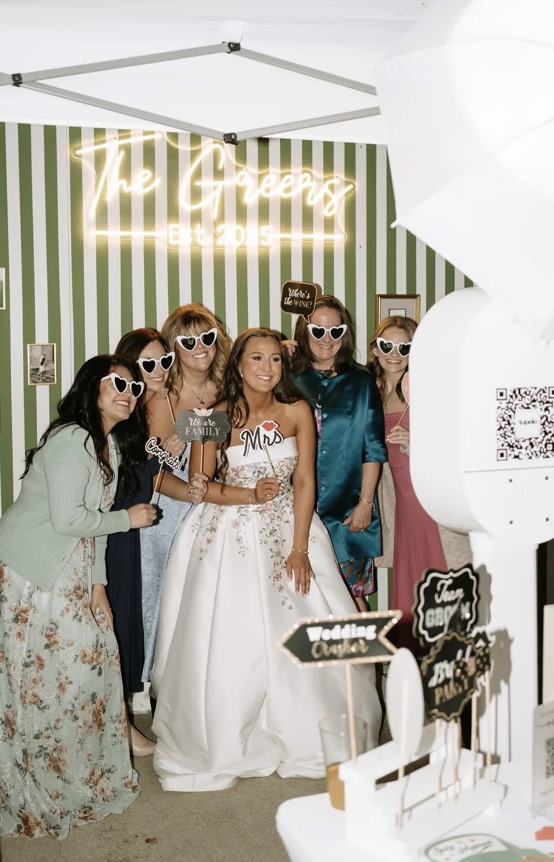 Bride with her guests next to the open air booth.