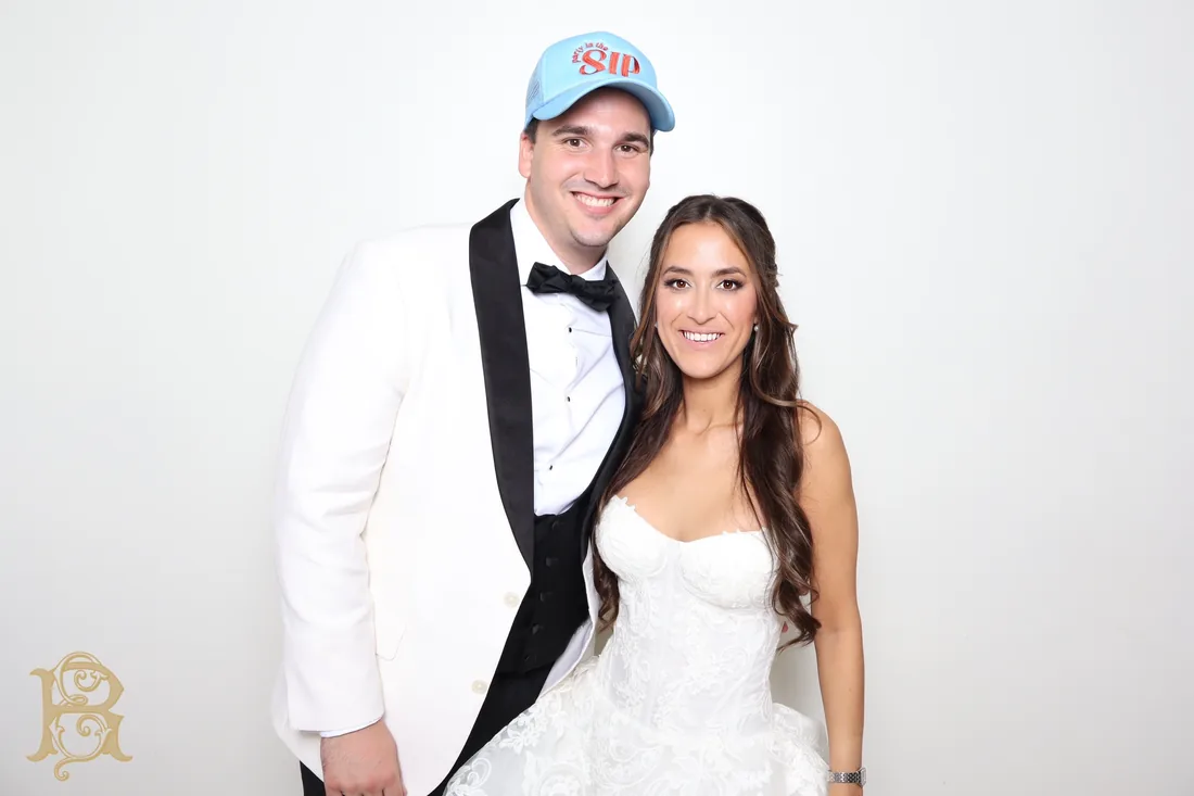 Bride and groom in the Glam Booth against a clean white backdrop.